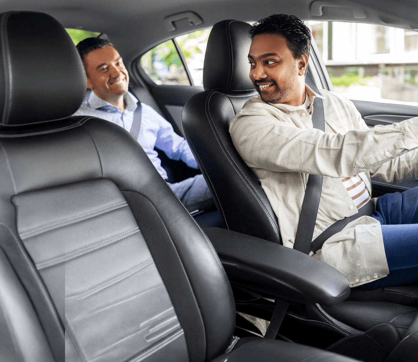 A Zippy chauffeur at the wheel with his passenger riding behind him