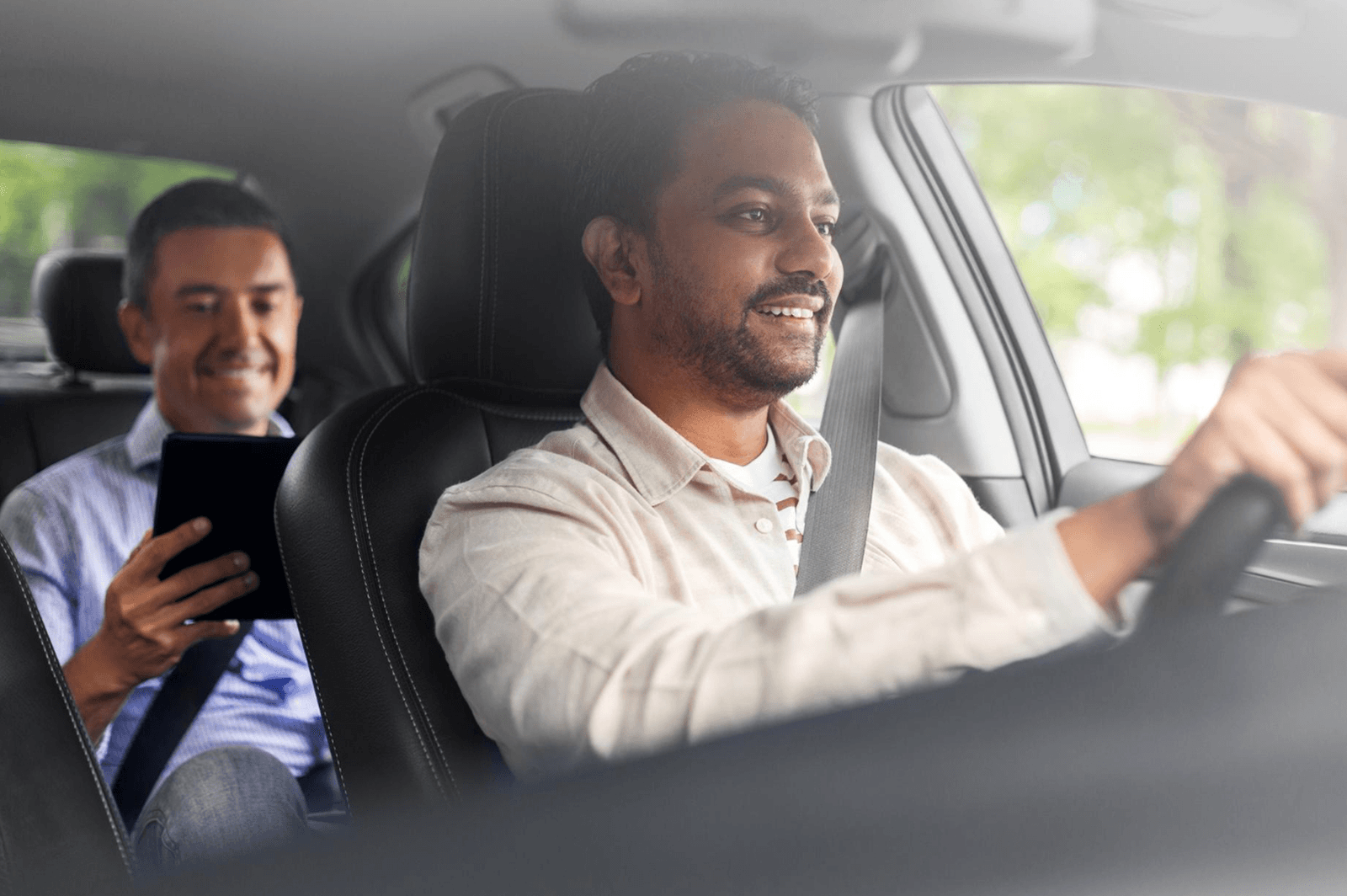 A Zippy chauffeur at the wheel while his passenger rides in the back