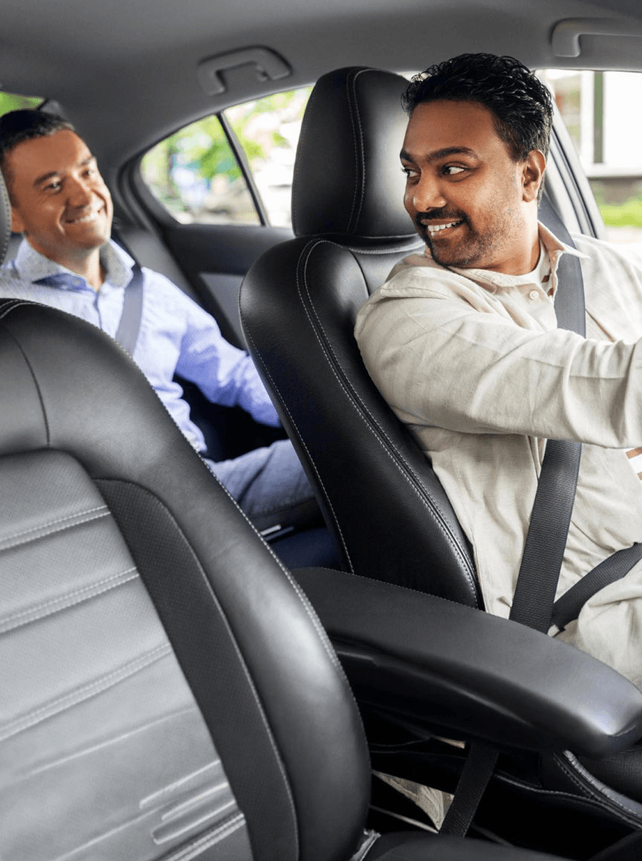 A Zippy chauffeur at the wheel with his passenger riding behind him