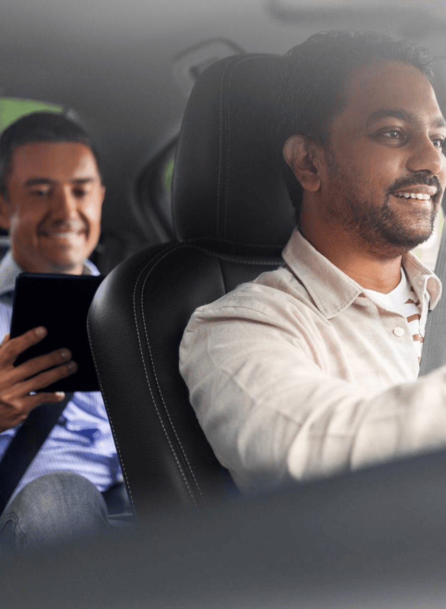 A Zippy chauffeur at the wheel while his passenger rides in the back